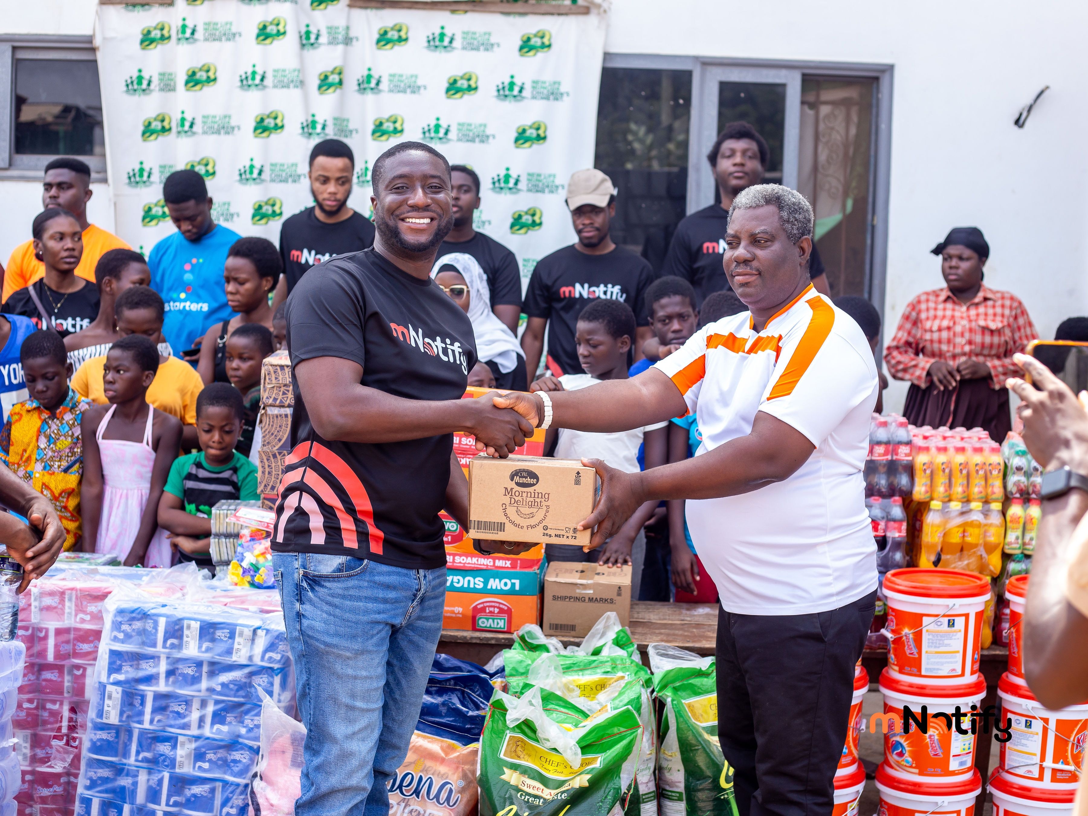 mNotify marks 12th anniversary with robotics training and donations at New Life Orphanage