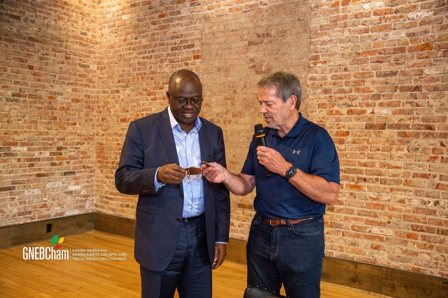 Jim Pillen presents Governor's coin to GNEBCham to signify growing bond